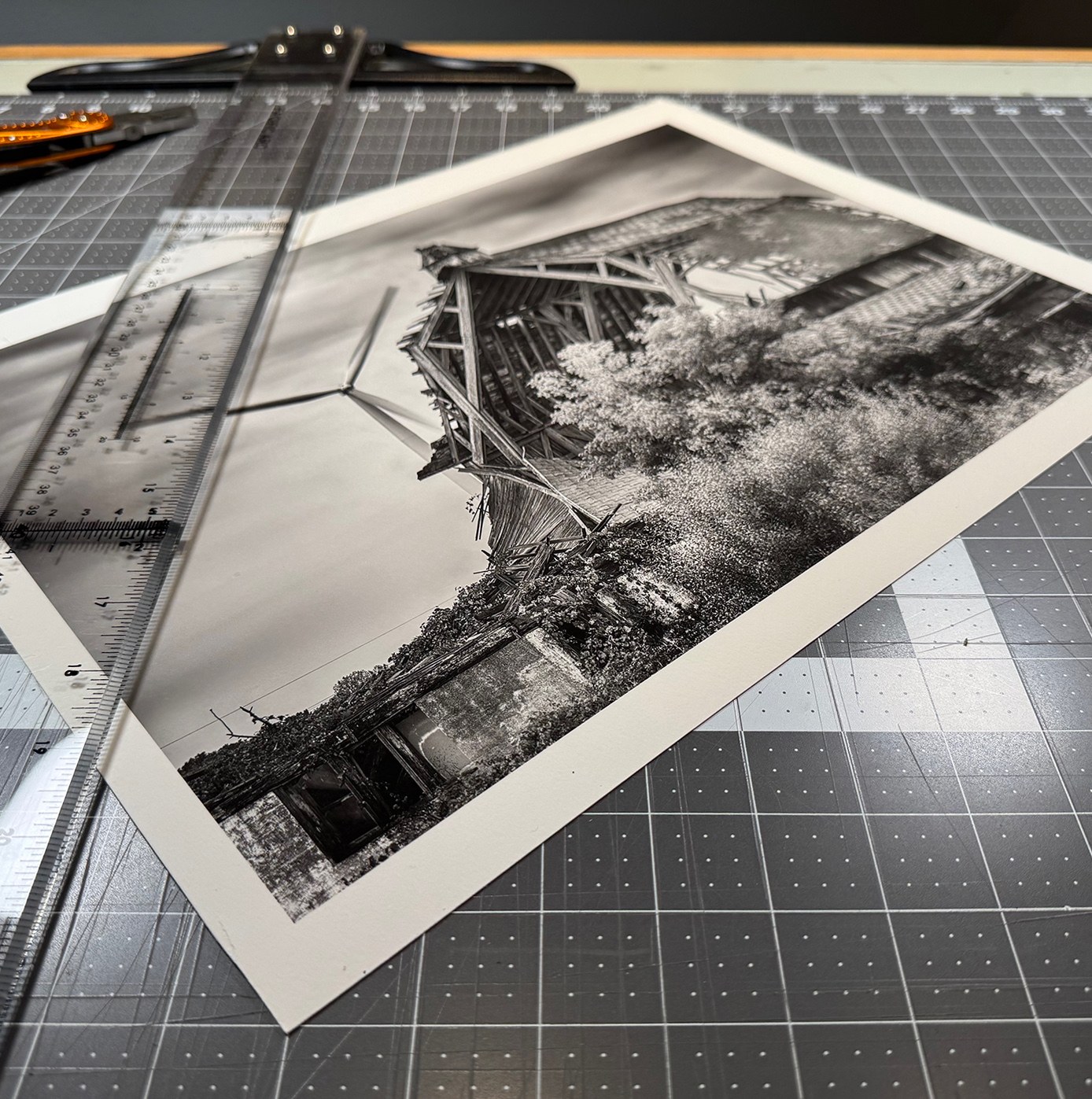 A signed print being carefully finished in the studio