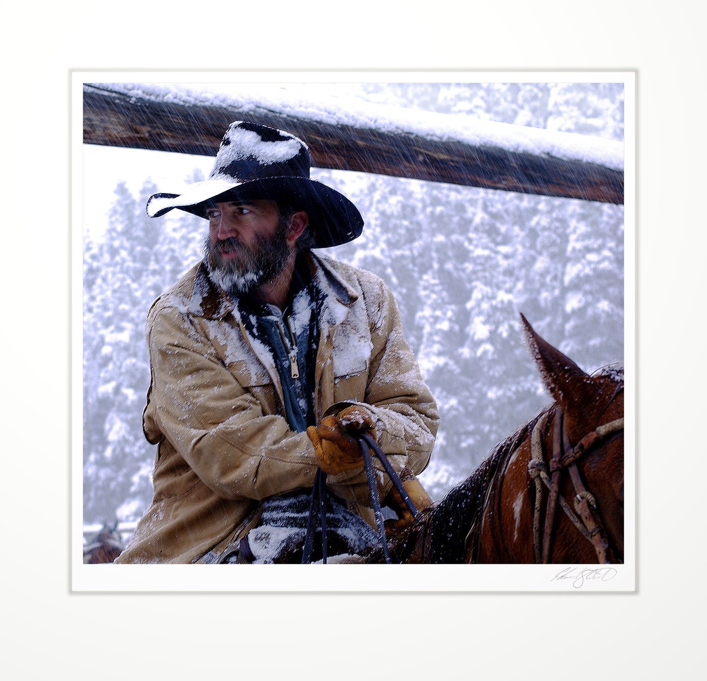 A wrangler on horseback in a heavy snowstorm. Rawah Ranch, Colorado -September 2001