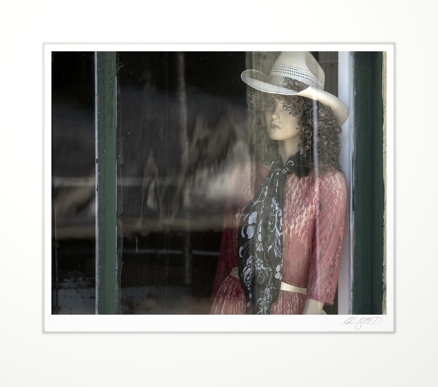 A lonesome mannequin in an old shop window at Unionville, Michigan -July, 2019