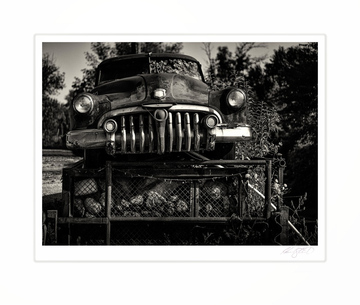 A close-up of a vintage car's grille and headlights in black and white. Quanicassee, Michigan -August 2025