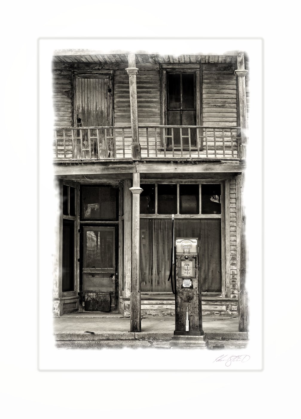 An old wooden storefront with a vintage gas pump and weathered balcony. Kilmanaugh, Michigan -2014