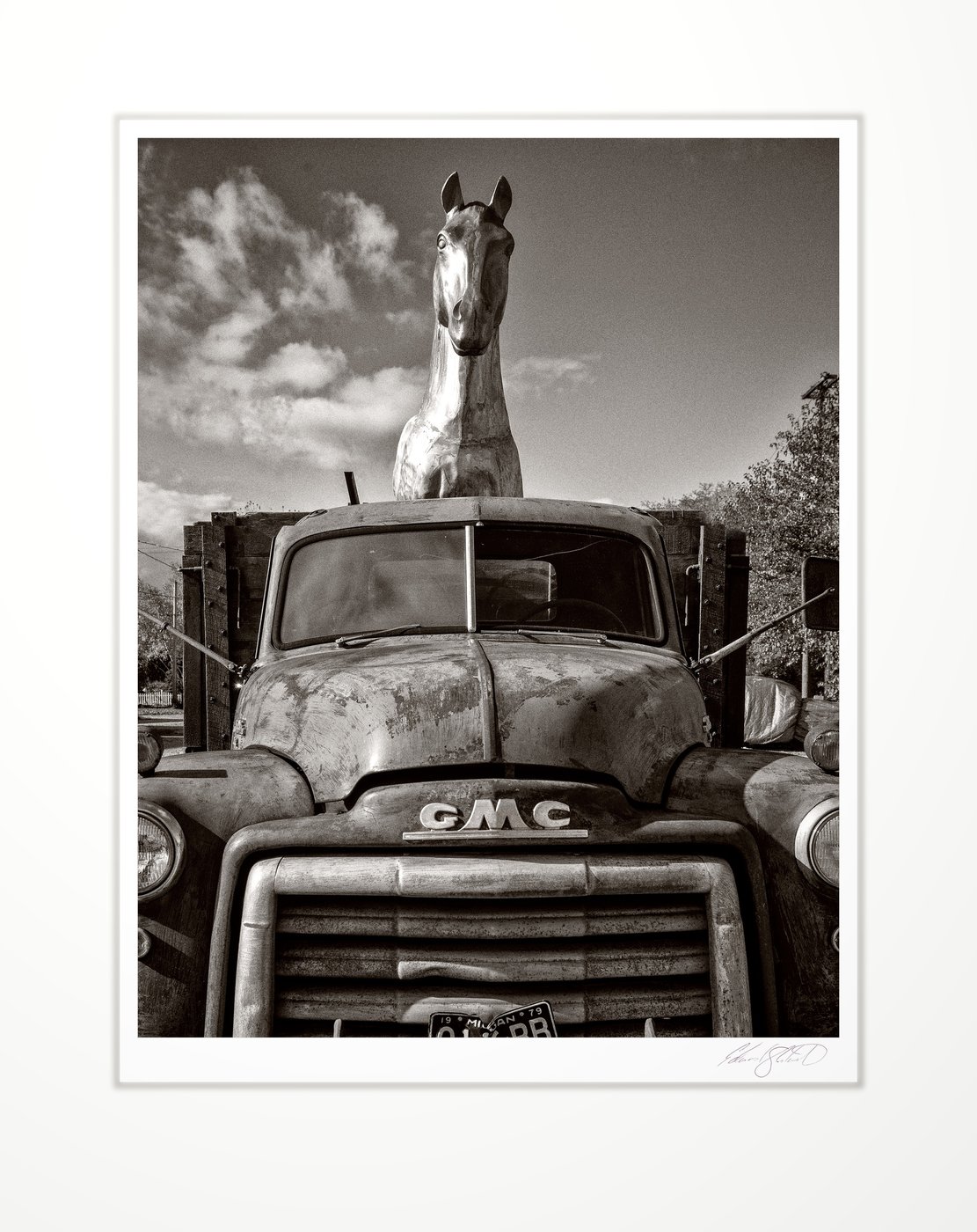 A vintage GMC truck with a horse sculpture mounted in the back Unionville, Michigan -November, 2019