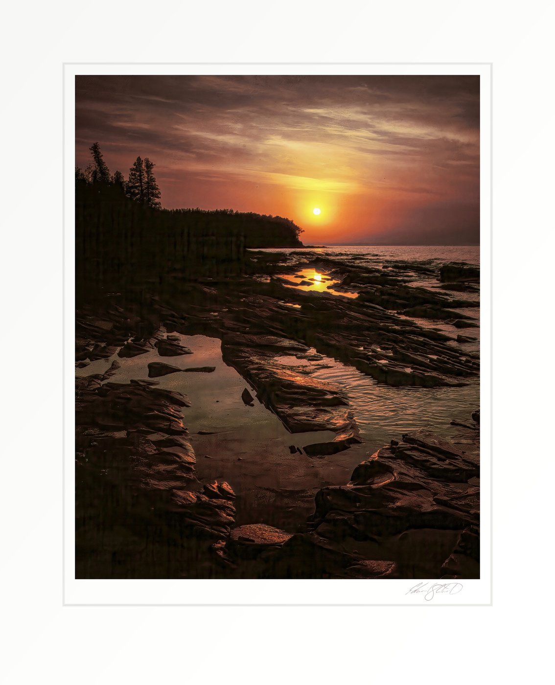 Sunrise over Lake Superior's rocky shoreline, with tide pools catching the golden light. Duluth, Minnesota -July, 1975