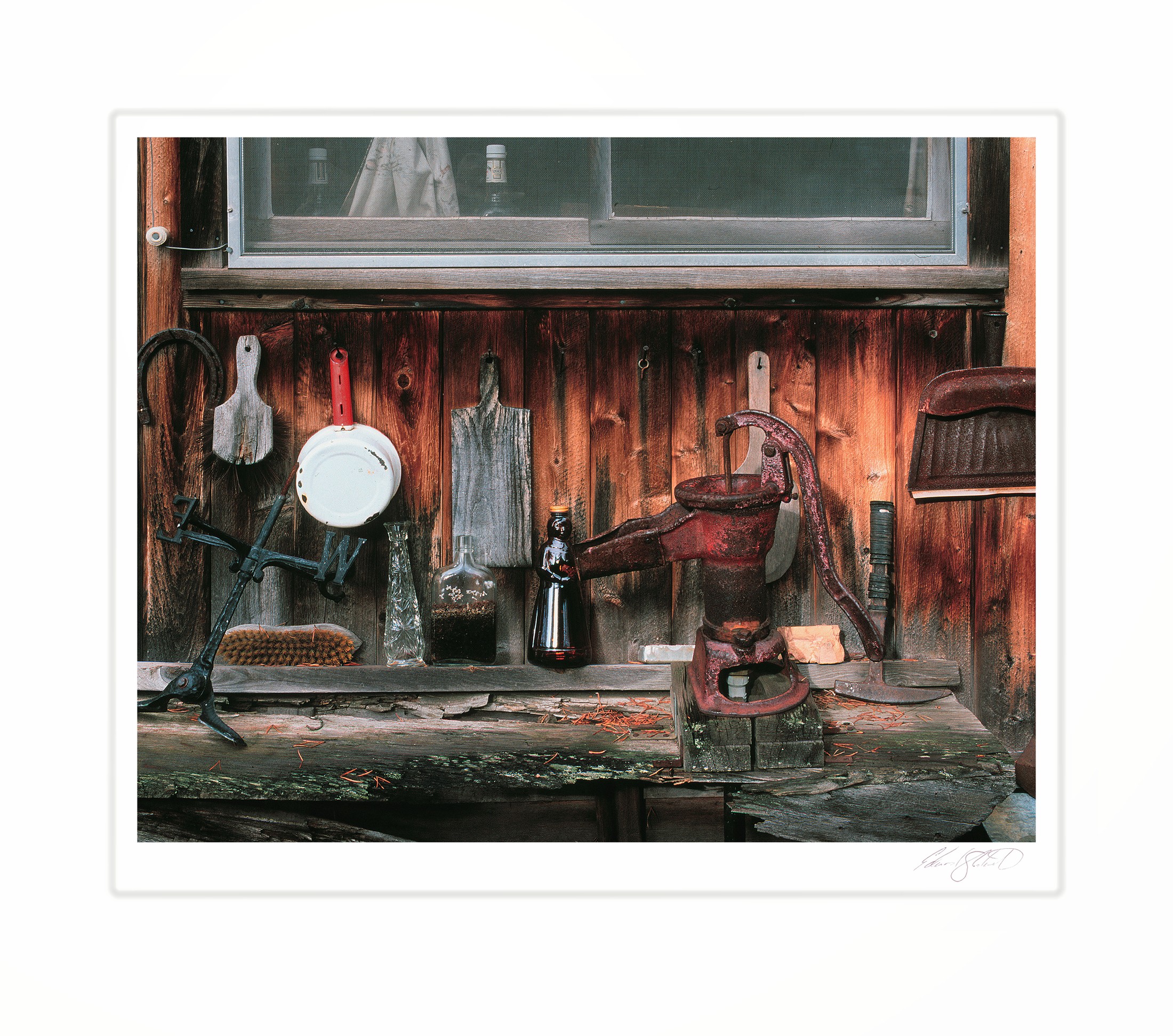 A rustic cabin porch with an old hand pump and antique bottles. Near Gwinn, Michigan -October 2000