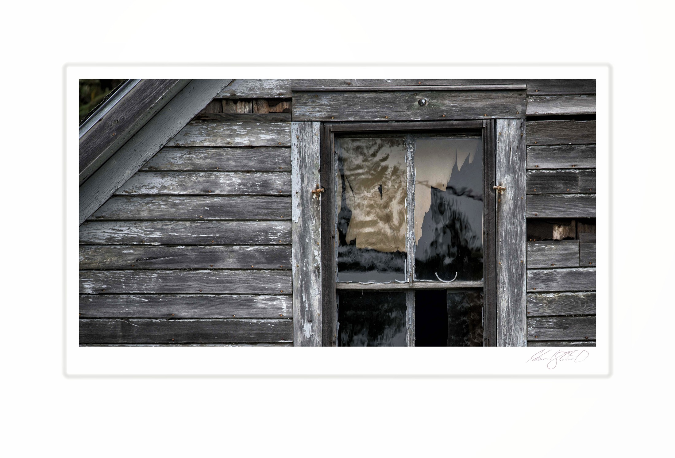 A weathered farmhouse window with peeling paint and broken glass. Engadine, Michigan -September 2016
