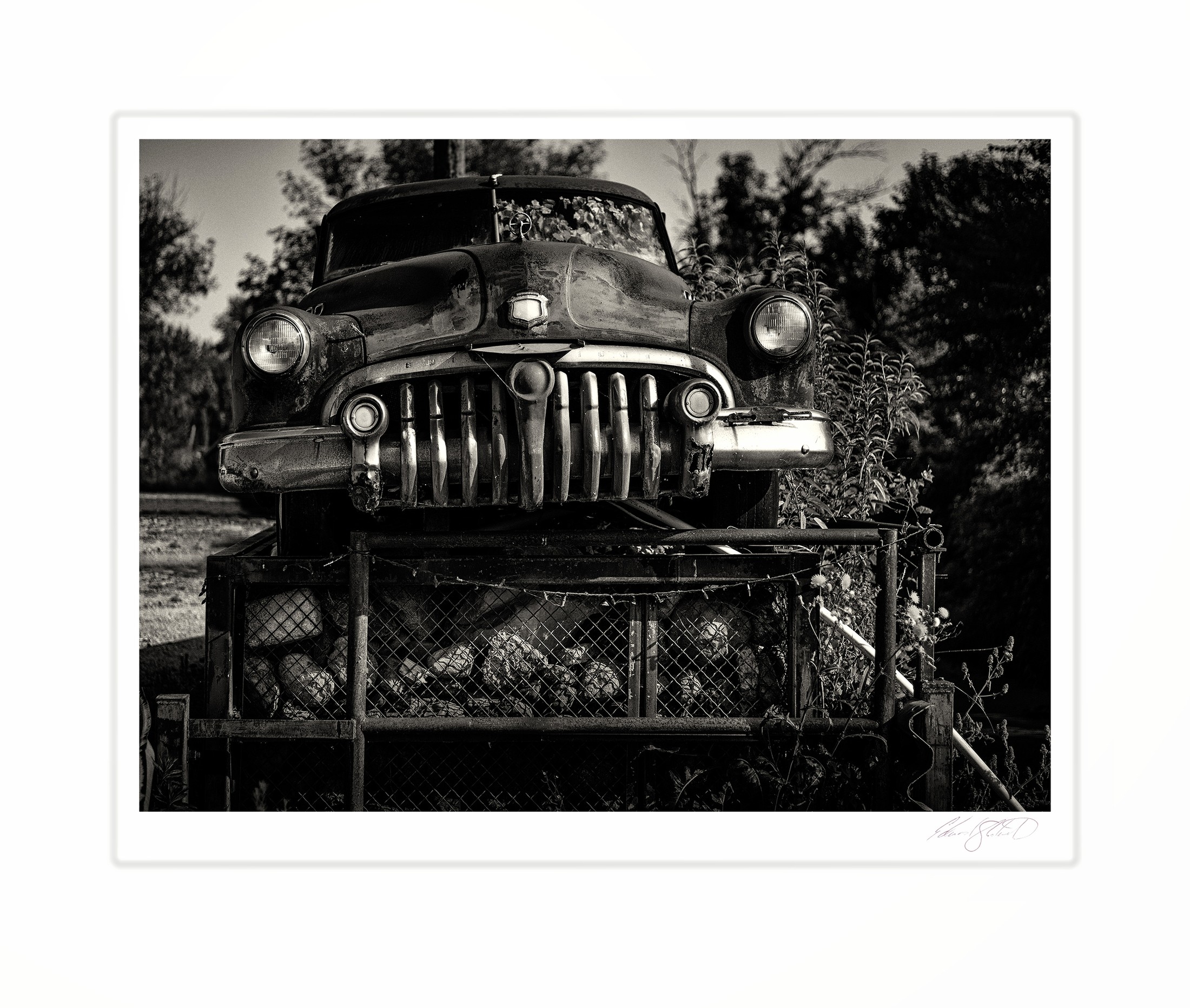 A close-up of a vintage car's grille and headlights in black and white. Quanicassee, Michigan -August 2025