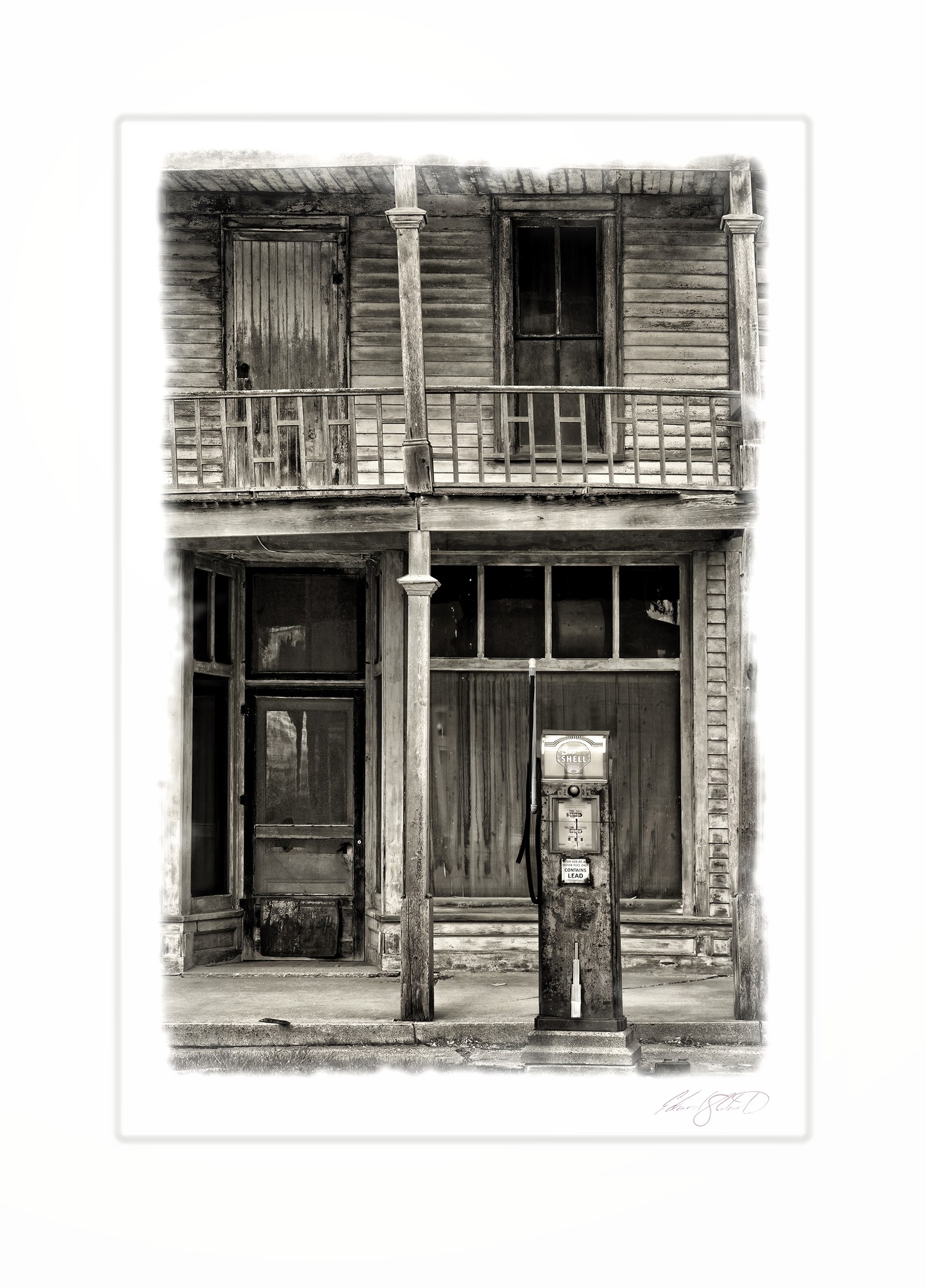 An old wooden storefront with a vintage gas pump and weathered balcony. Kilmanaugh, Michigan -2014